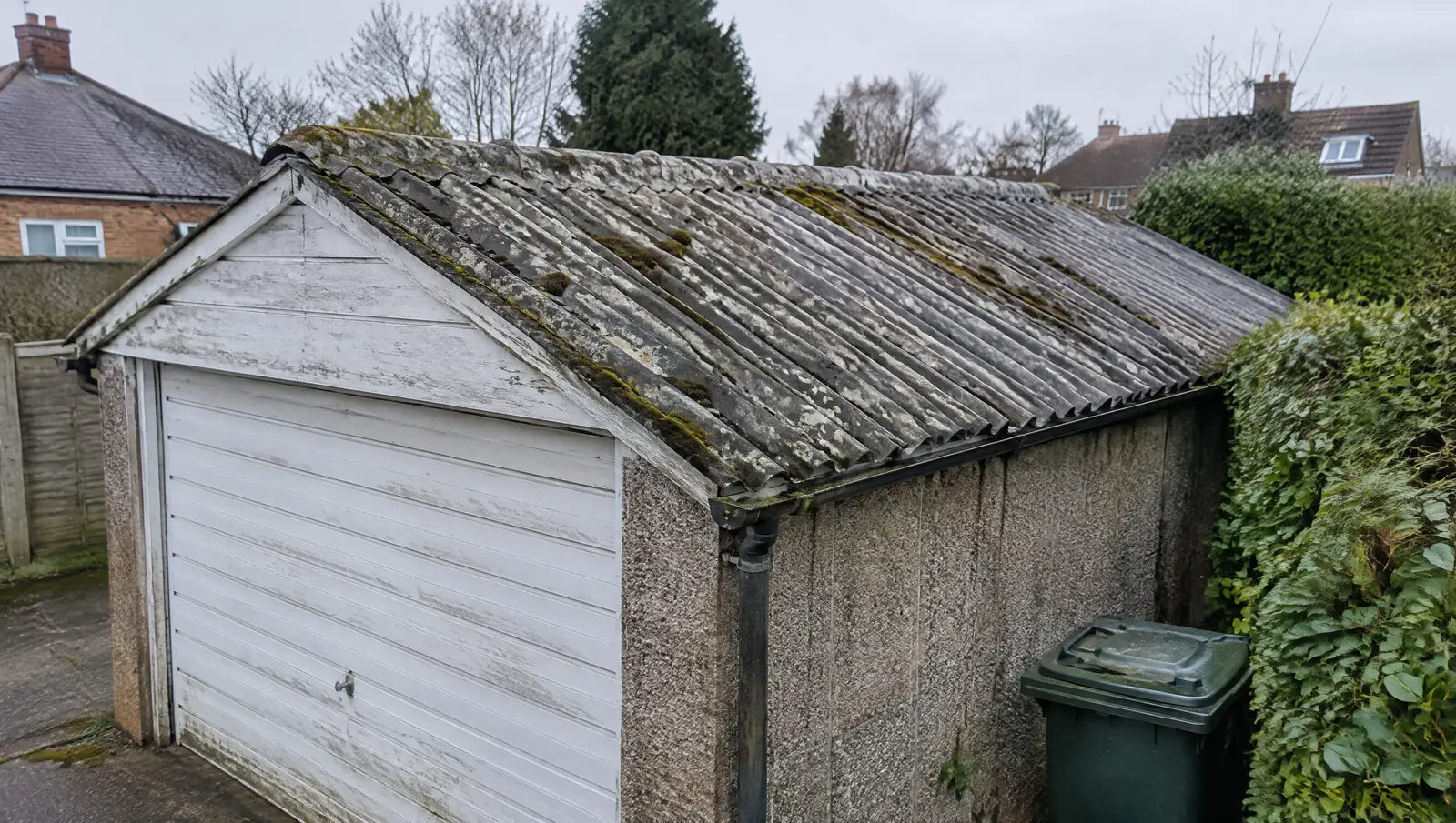 Weathered corrugated asbestos cement roof on an old British detached garage