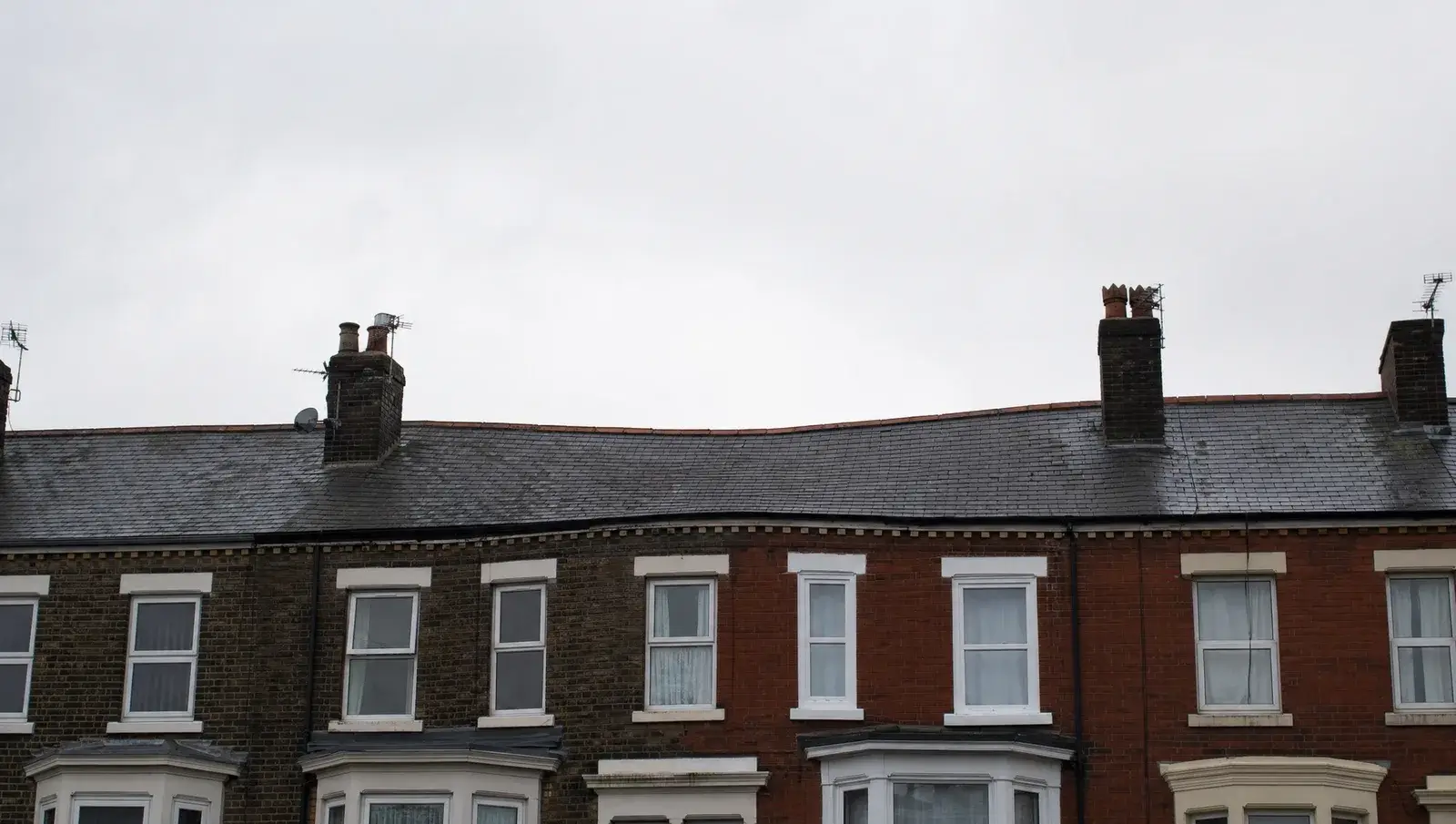 Older UK terraced house with a visibly dipped and sagging roof ridge line