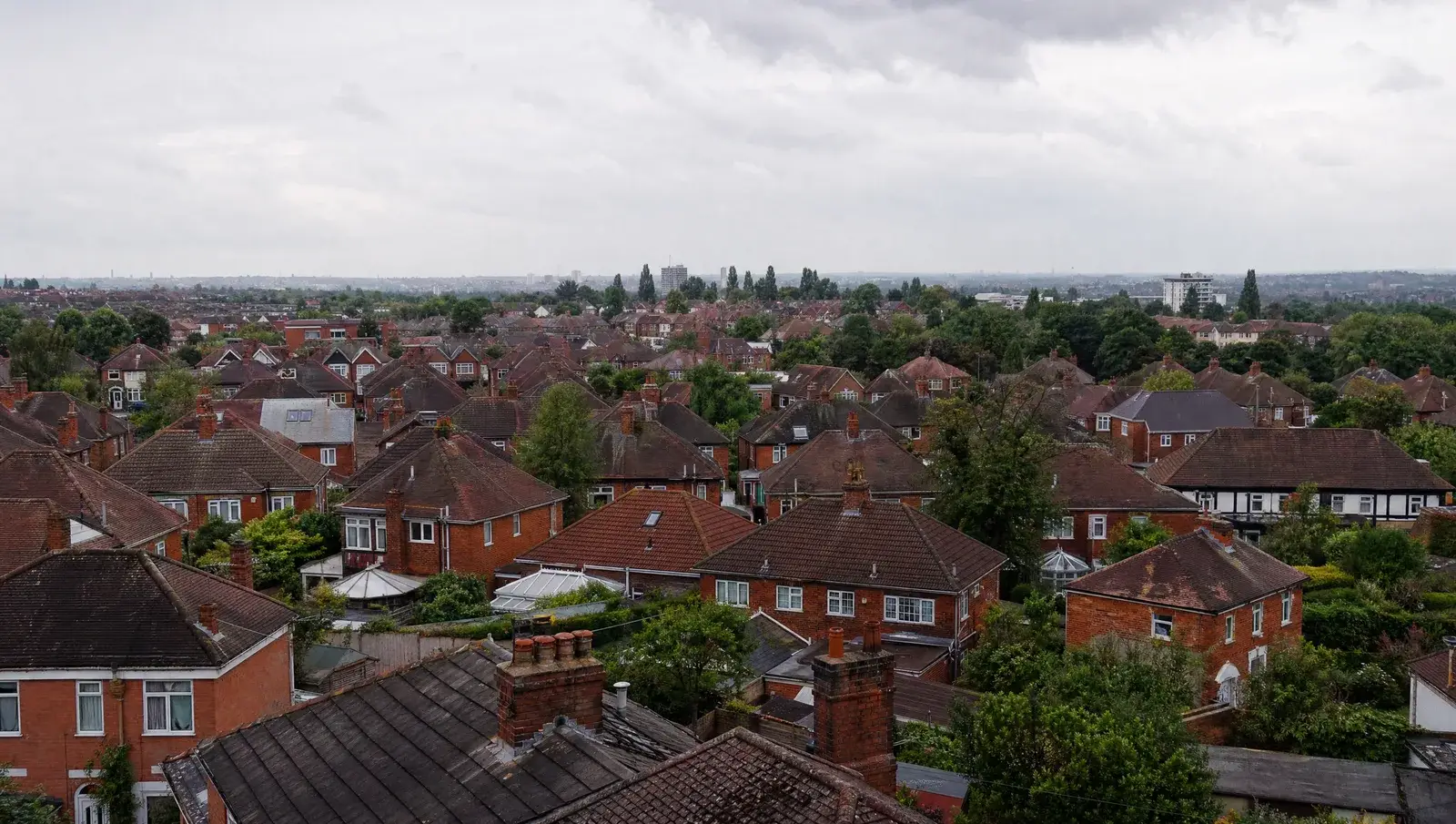 Red-brick Birmingham suburban rooftops with concrete tiled interwar semis