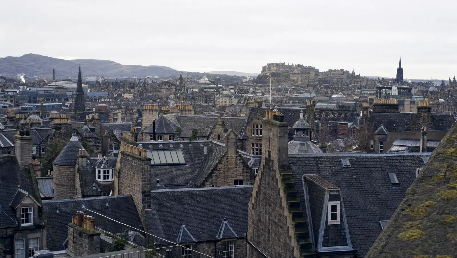 Edinburgh Old Town slate rooftops with crow-step gables and the castle in the distance