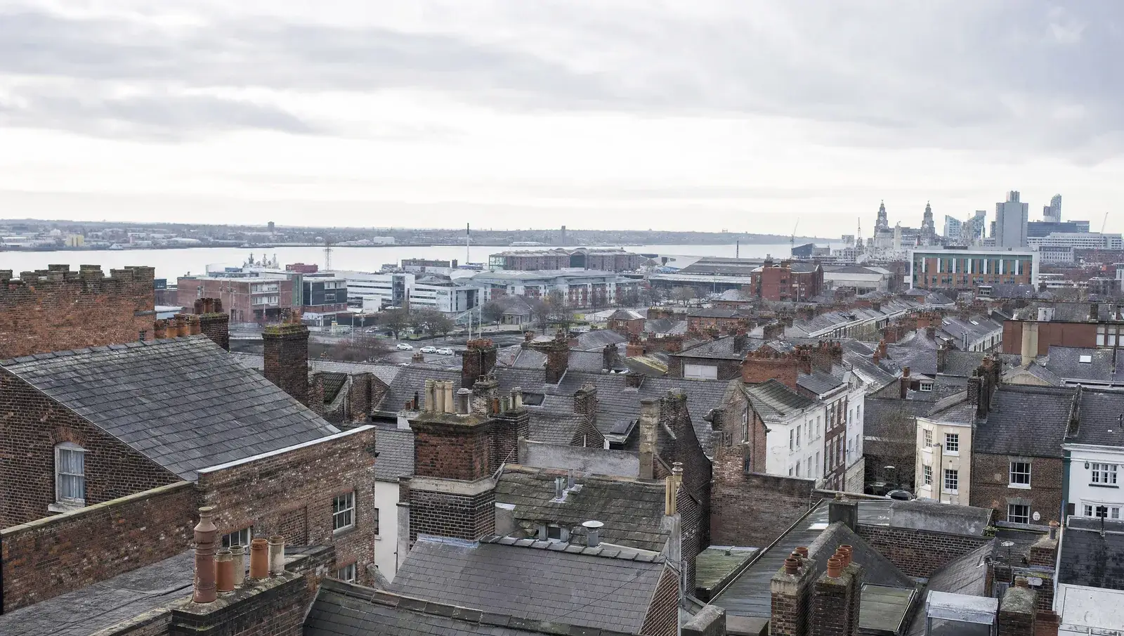 Liverpool Georgian and Victorian terraced rooftops with the docks in the far distance