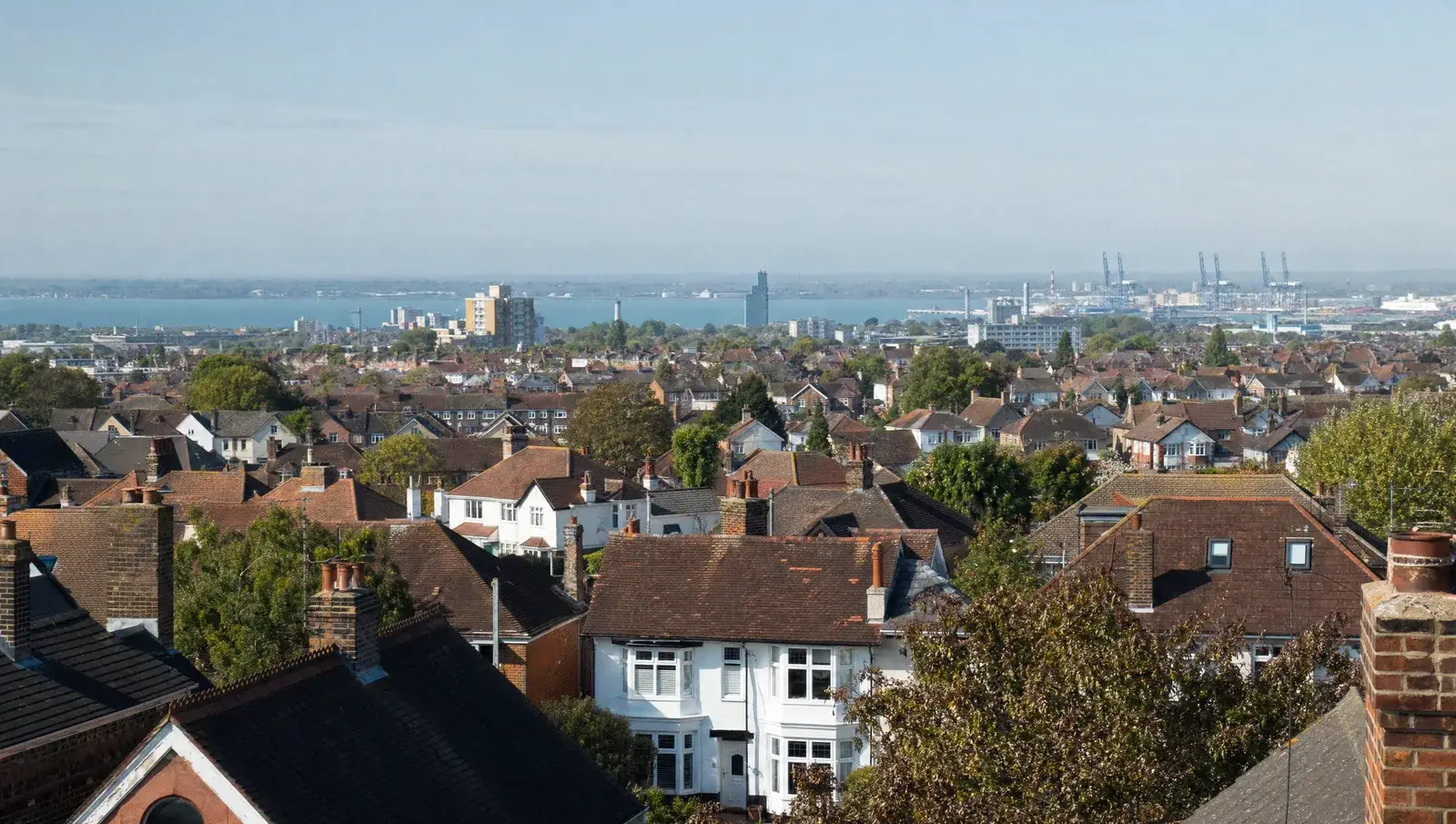 Southampton suburban rooftops with tiled interwar houses and the port in the far distance