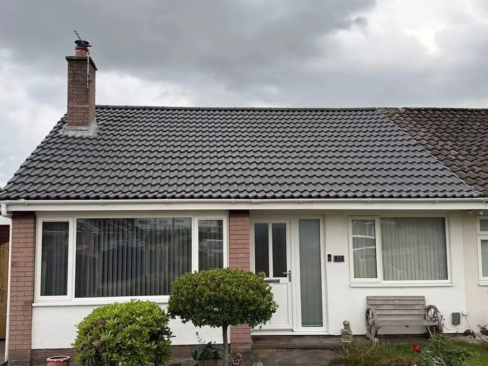 Bungalow front with a new grey tiled roof