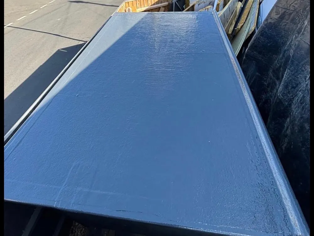 Finished grey GRP fibreglass flat roof with new edge trims