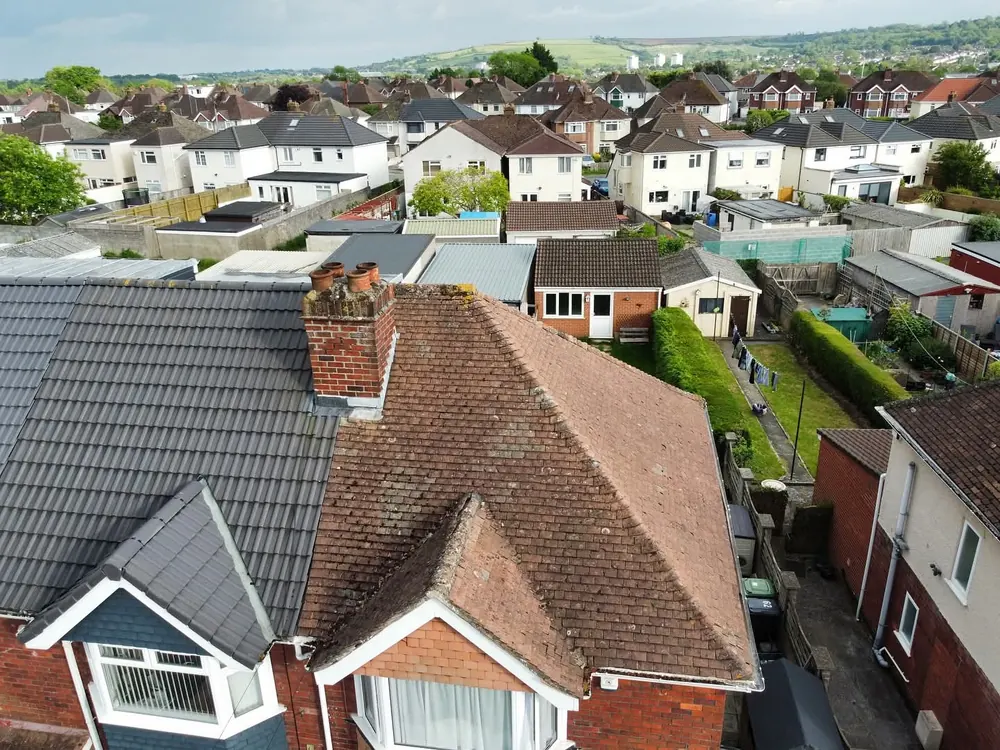 Aerial view of a finished roof with chimney above a Bristol street