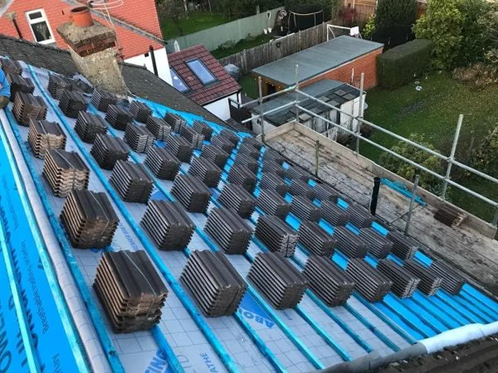 Tiles loaded out on new battens and breathable membrane during a re-roof