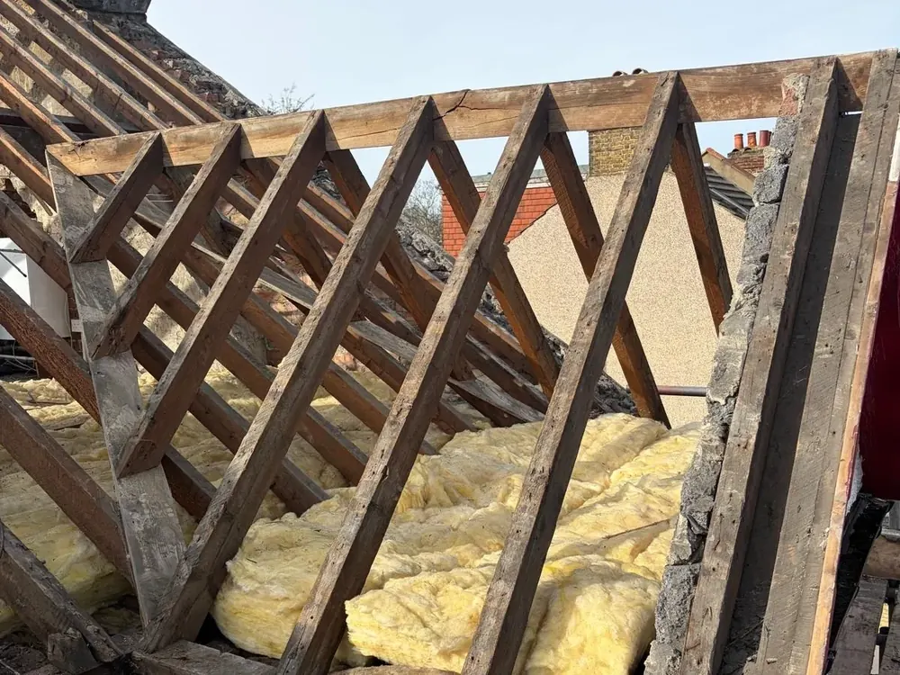 Exposed roof timbers and insulation during a roof strip and rebuild