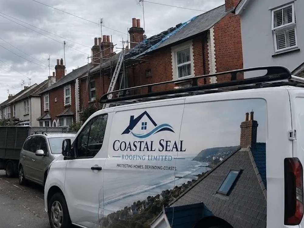 The Coastal Seal Roofing liveried van on a terraced street during roof work