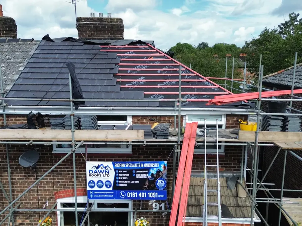 Drone view of a semi re-roof under way with the Dawn Roofs scaffold banner
