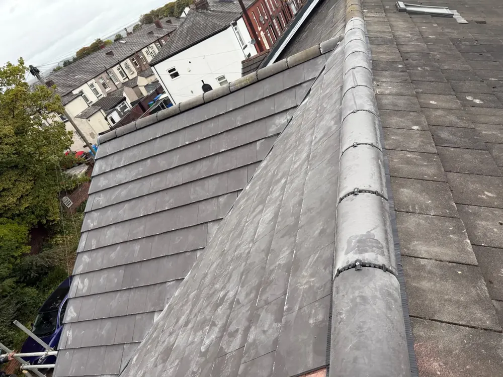 Grey concrete tile roof with a new ridge line