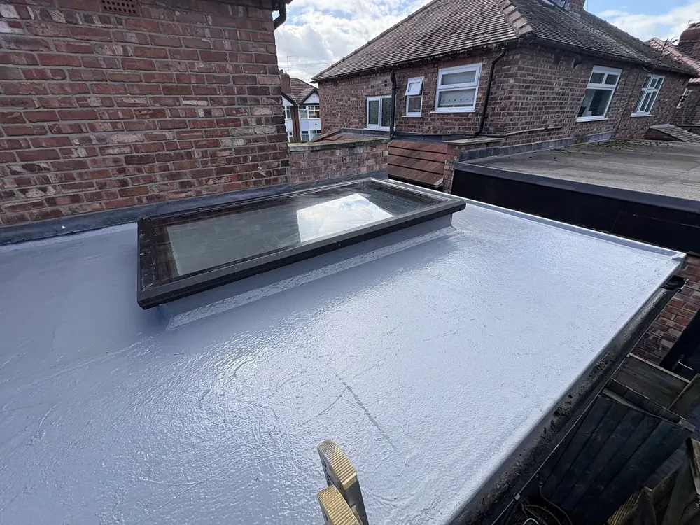 Finished grey GRP fibreglass flat roof with a rooflight