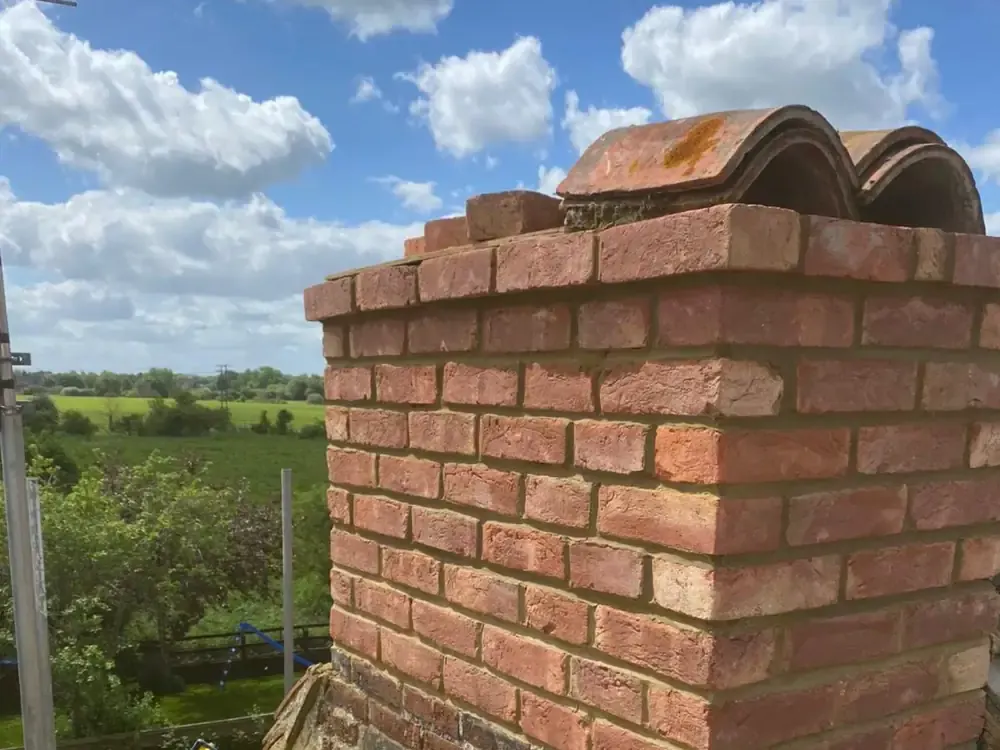 Rebuilt brick chimney stack with new pots