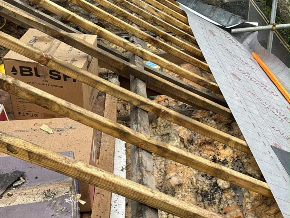 Old rotten battens and roof timbers exposed once the old covering was stripped off