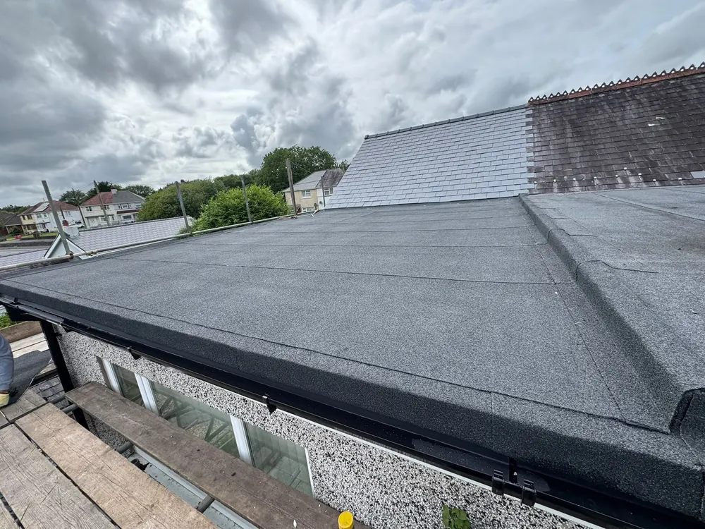 New felt flat roof on a single-storey extension with scaffold still up