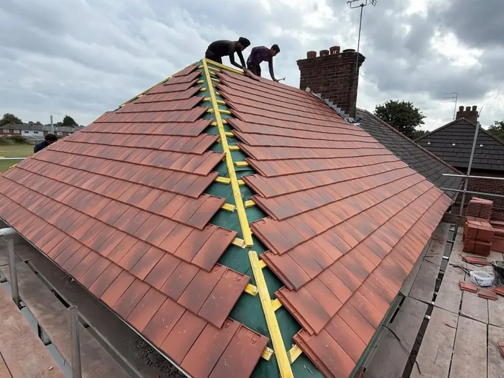 The team fixing a dry ridge on a new tiled roof in East Grinstead