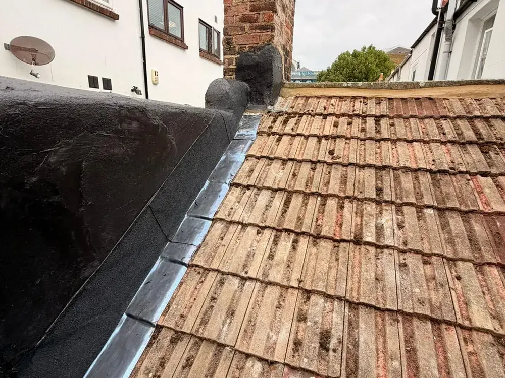 New lead flashing along a parapet wall during a re-roof