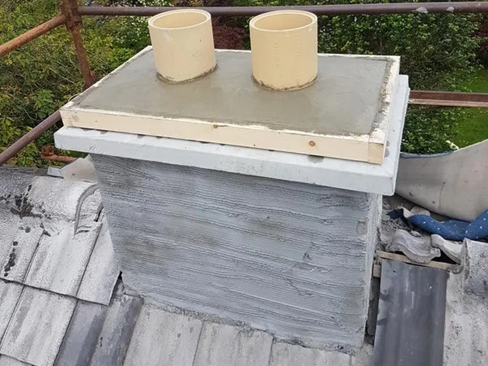 Rebuilt chimney stack rendered and capped with two new pots