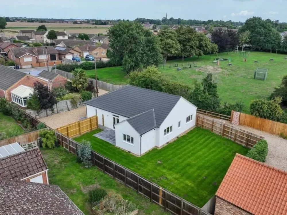 Aerial view of the completed Leverington bungalow with its new grey tiled roof and garden