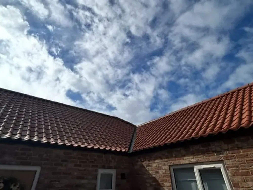 Completed clay pantile roof meeting at a valley