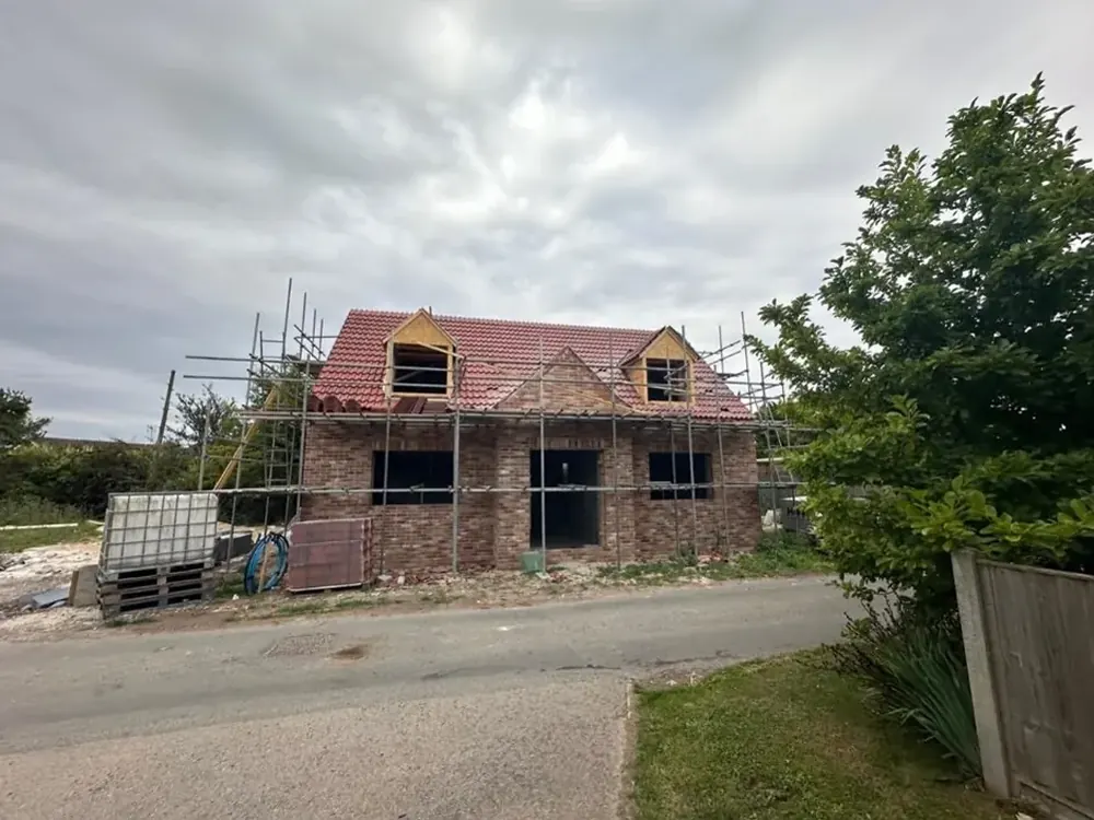 New dormer house with its clay tile roof on during construction