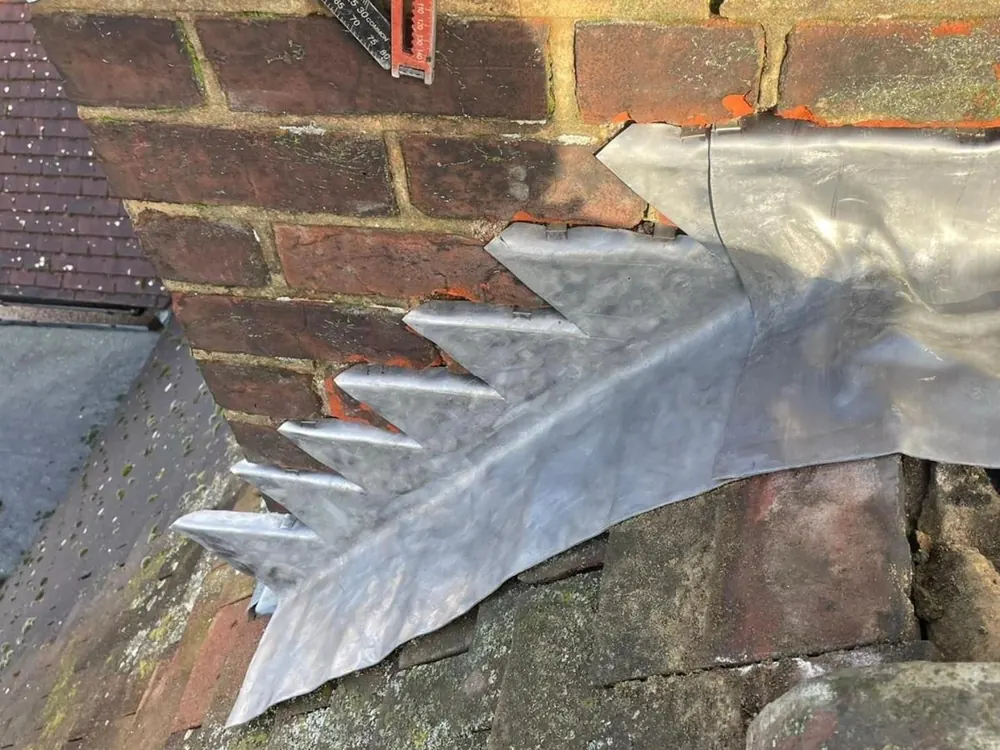 Lead step and cover flashing up the side of a chimney