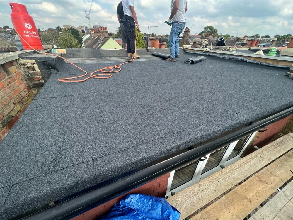 Team finishing a mineral felt flat roof