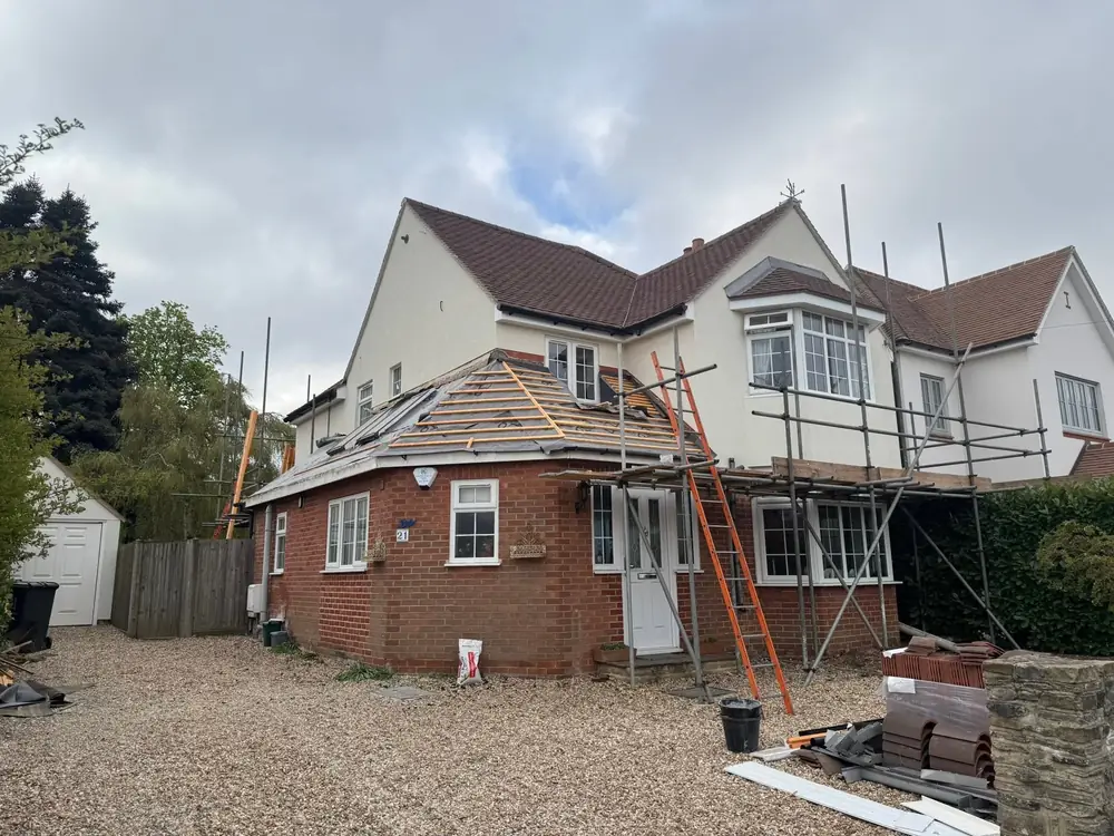 Detached house in Farnham with a new tiled roof and scaffold at the front