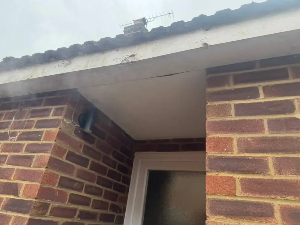 New white uPVC soffit and fascia over a brick bay in Fleet