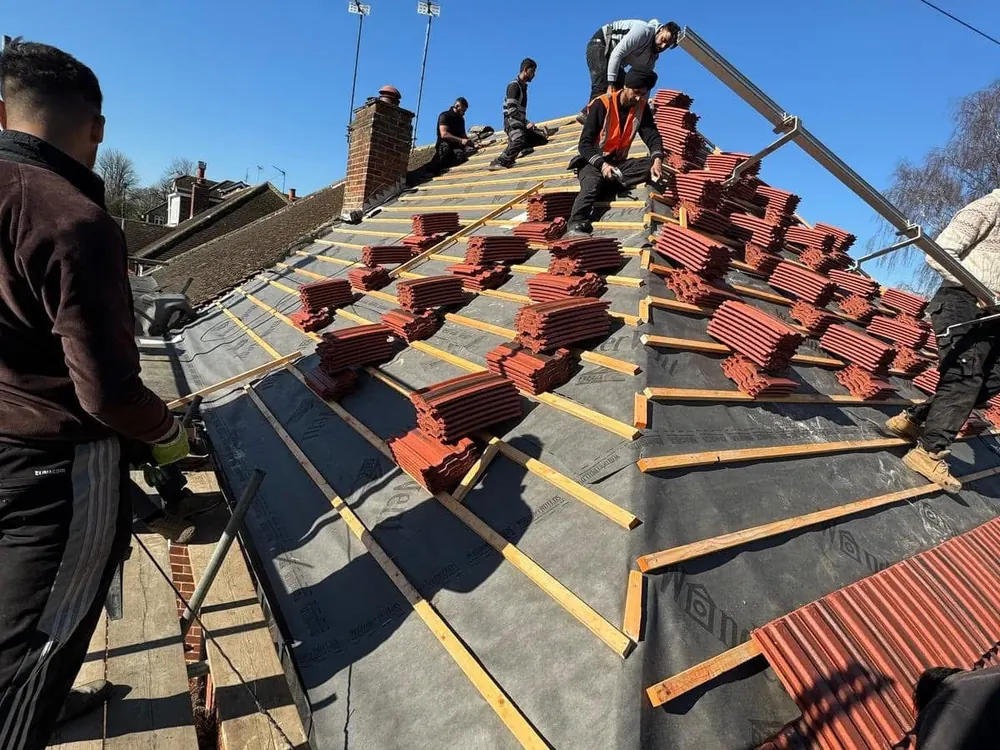 Nationwide roofers loading out and laying red tiles over new membrane and battens