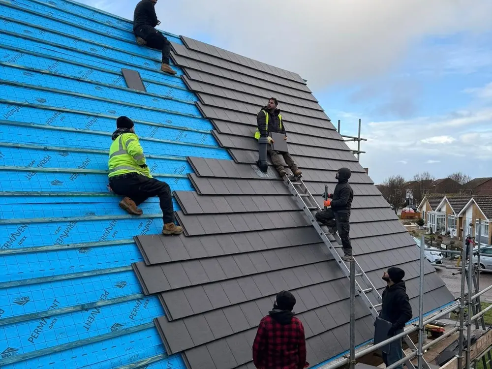 Team tiling over new blue breathable membrane