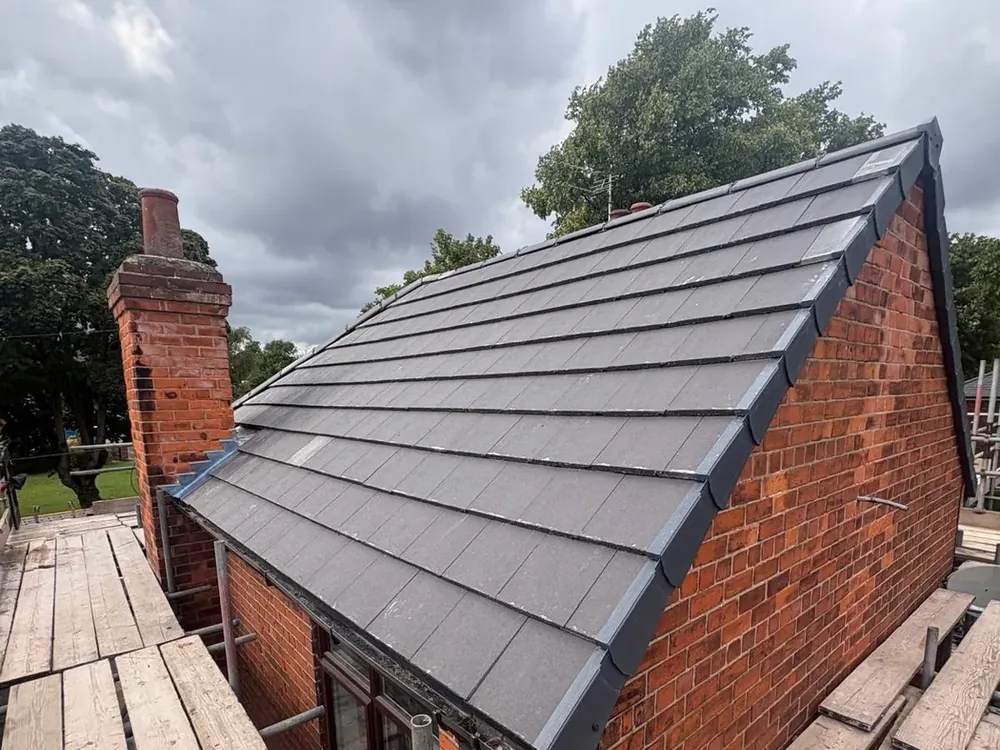 Grey flat tile roof and dry verge on the gable end of a Beverley property
