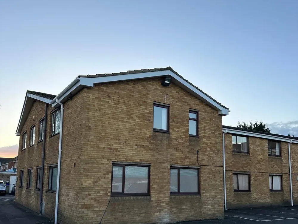 New white fascia, soffit and guttering fitted to a two storey block of flats