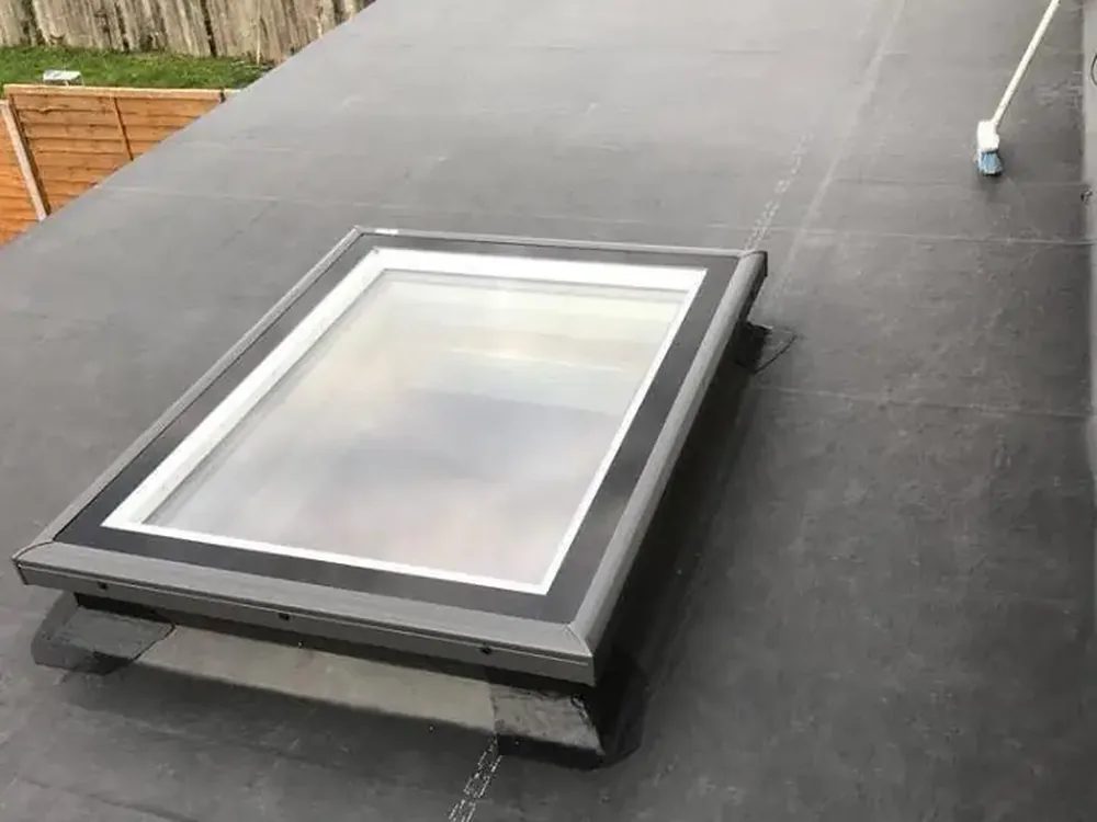 EPDM rubber flat roof with a fitted skylight overlooking a garden