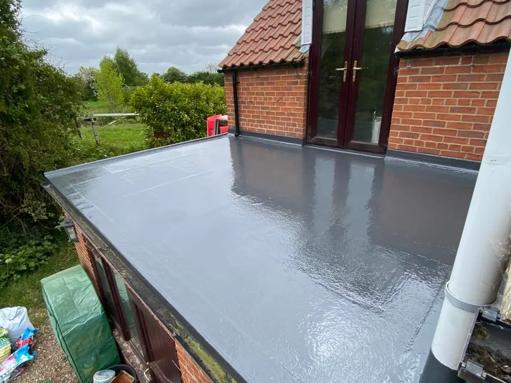 New grey flat roof on a rear extension beside the French doors