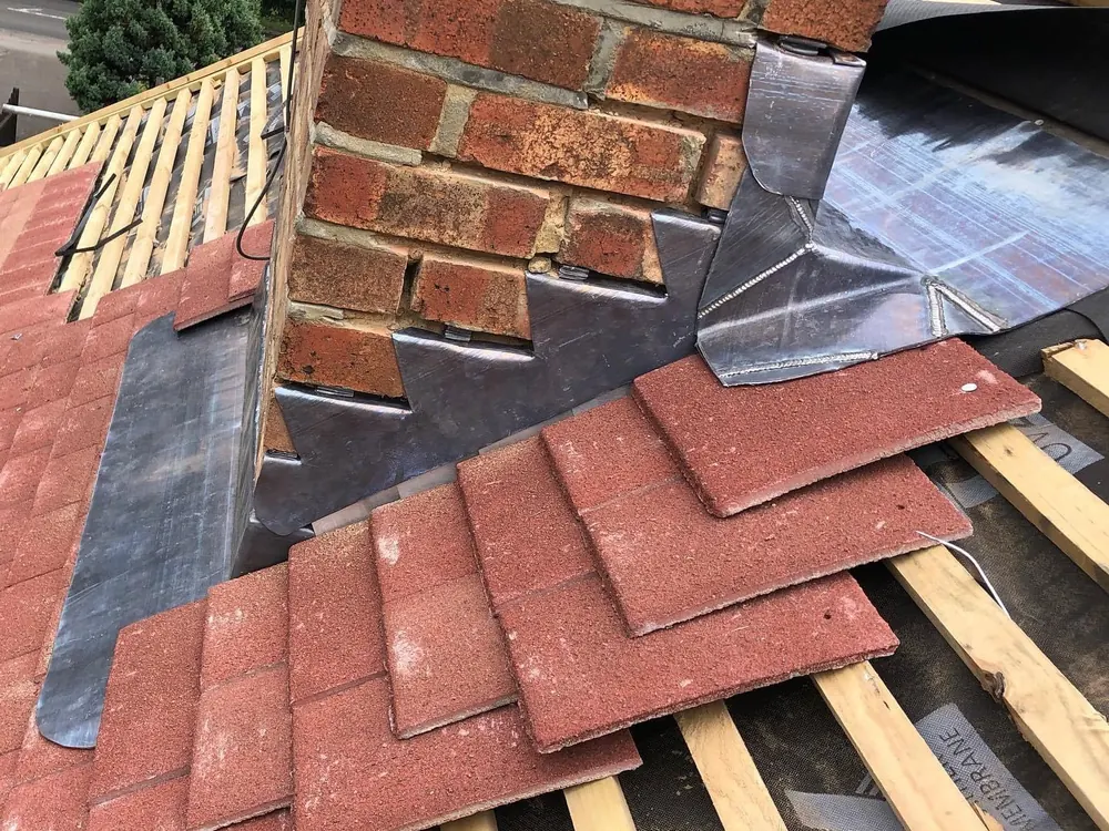Chimney with new lead soakers and red tiles going on
